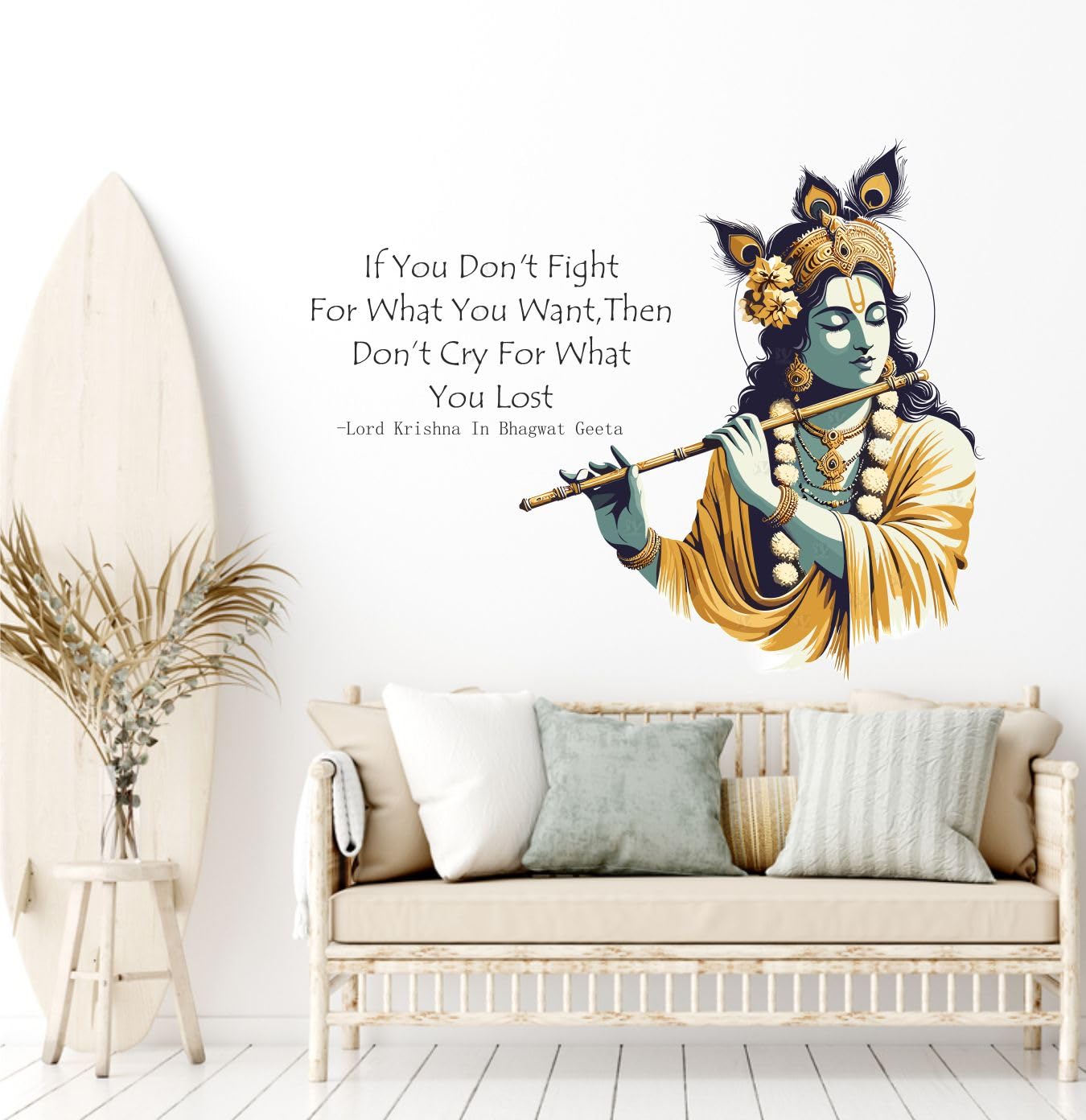 Wall decal of a deity holding a flute above a sofa with a motivational quote on a white wall.