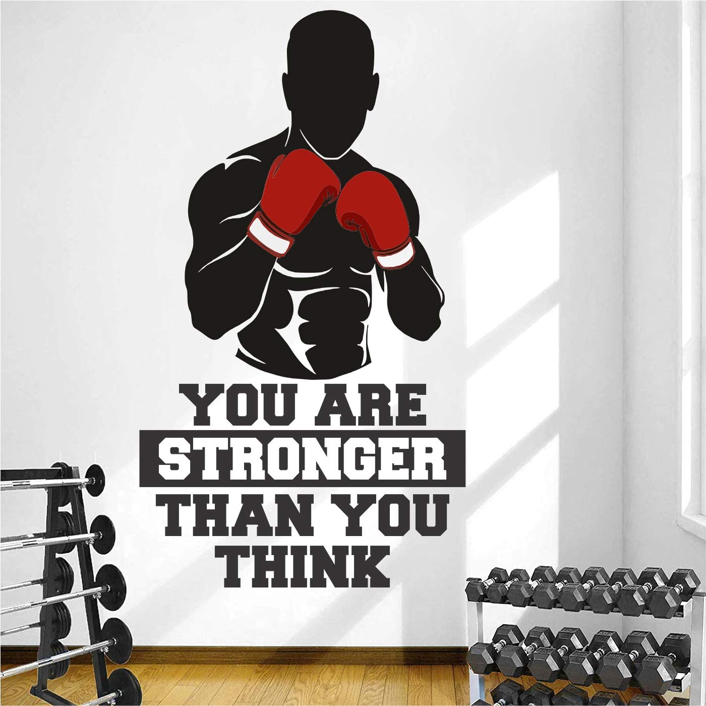 Wall decal of a boxer with 'You are stronger than you think' quote in a gym setting