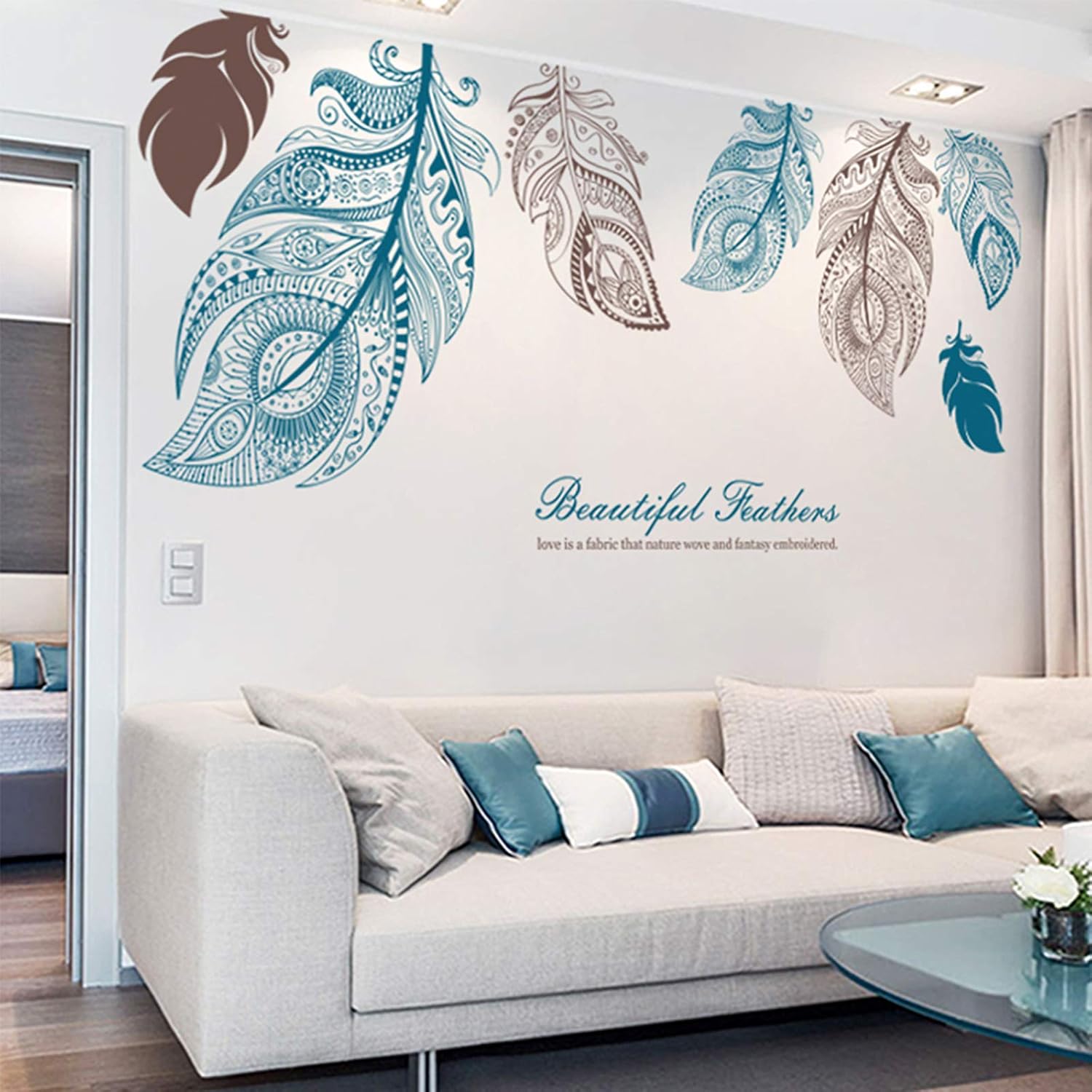 Living room with decorative wall stickers of feathers and 'Beautiful Feathers' text.