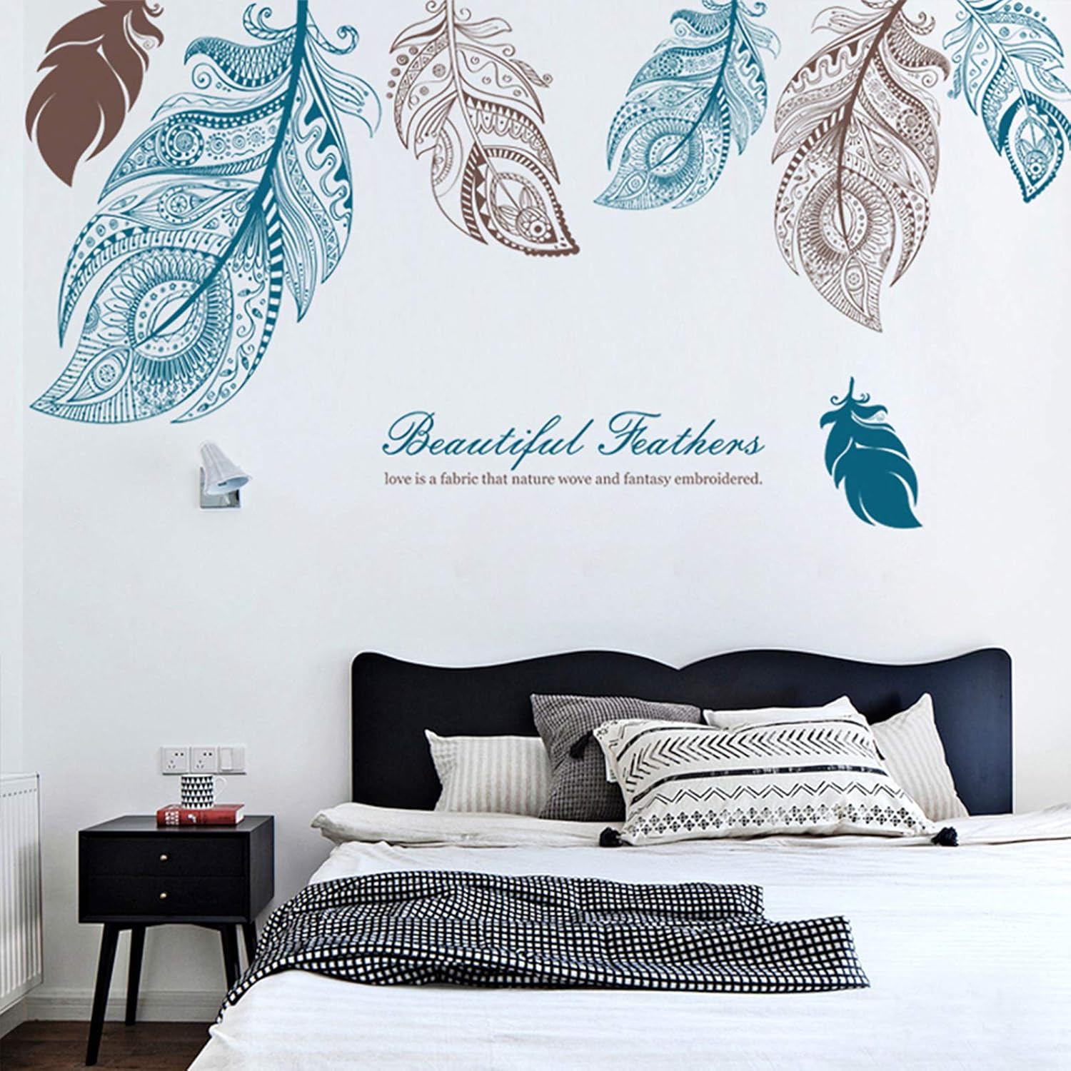 Bedroom with decorative feather wall decals on a white wall.