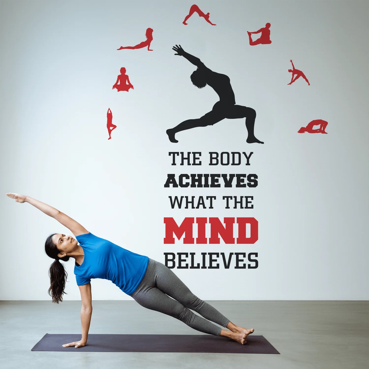 Woman in a yoga pose with motivational quote on a wall