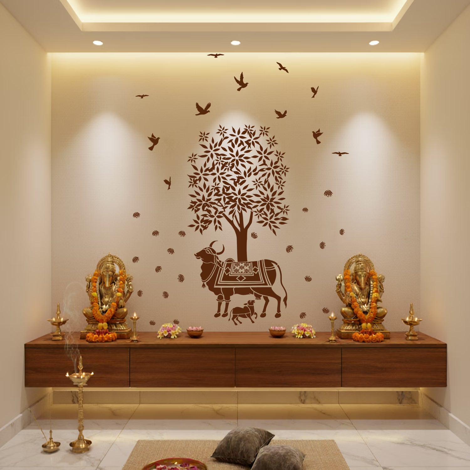 Decorative wall with a tree and animals design, along with religious statues and offerings on a wooden platform.