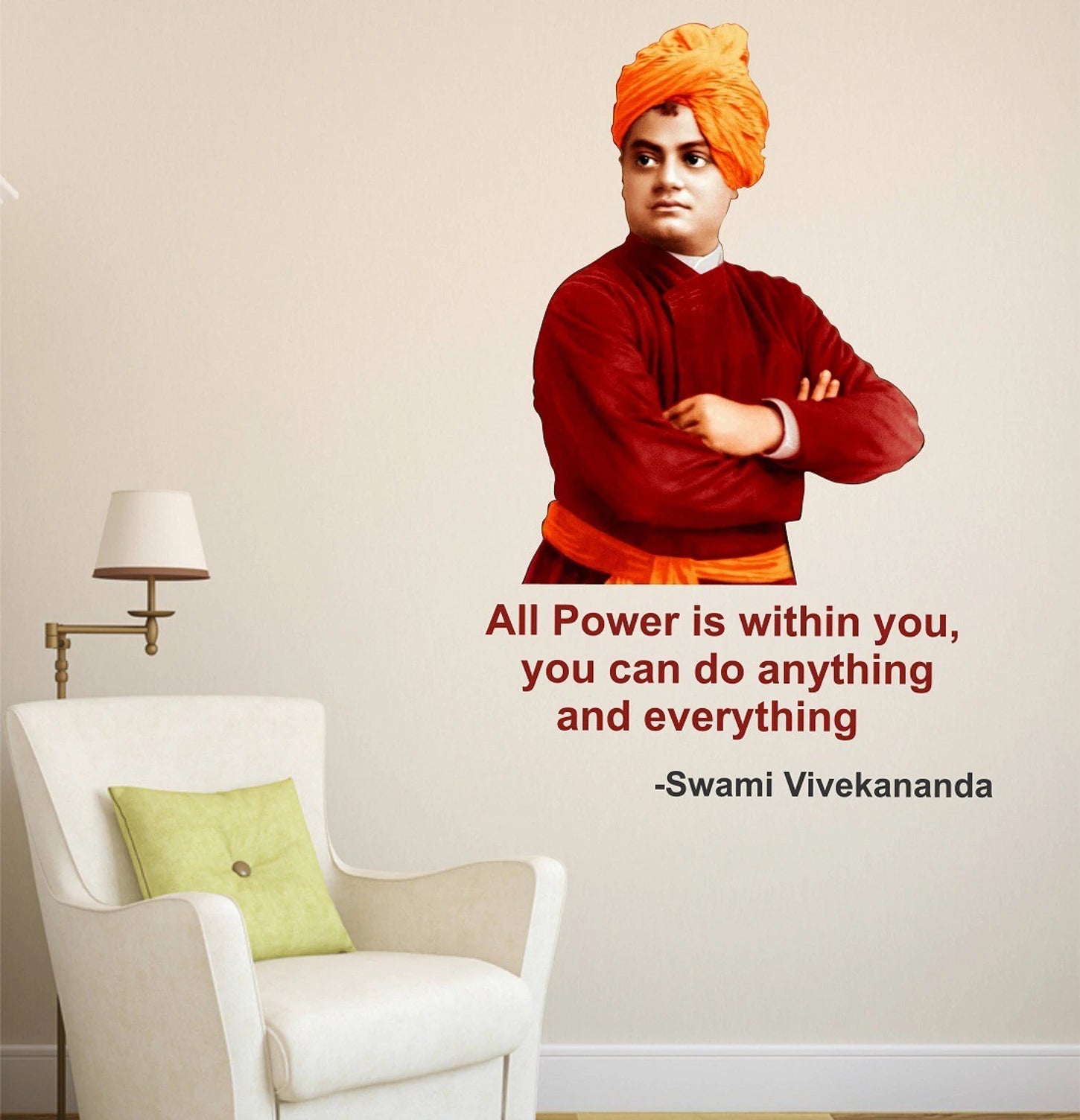 Swami Vivekananda in red outfit with orange turban in a room with a white chair and green pillow.