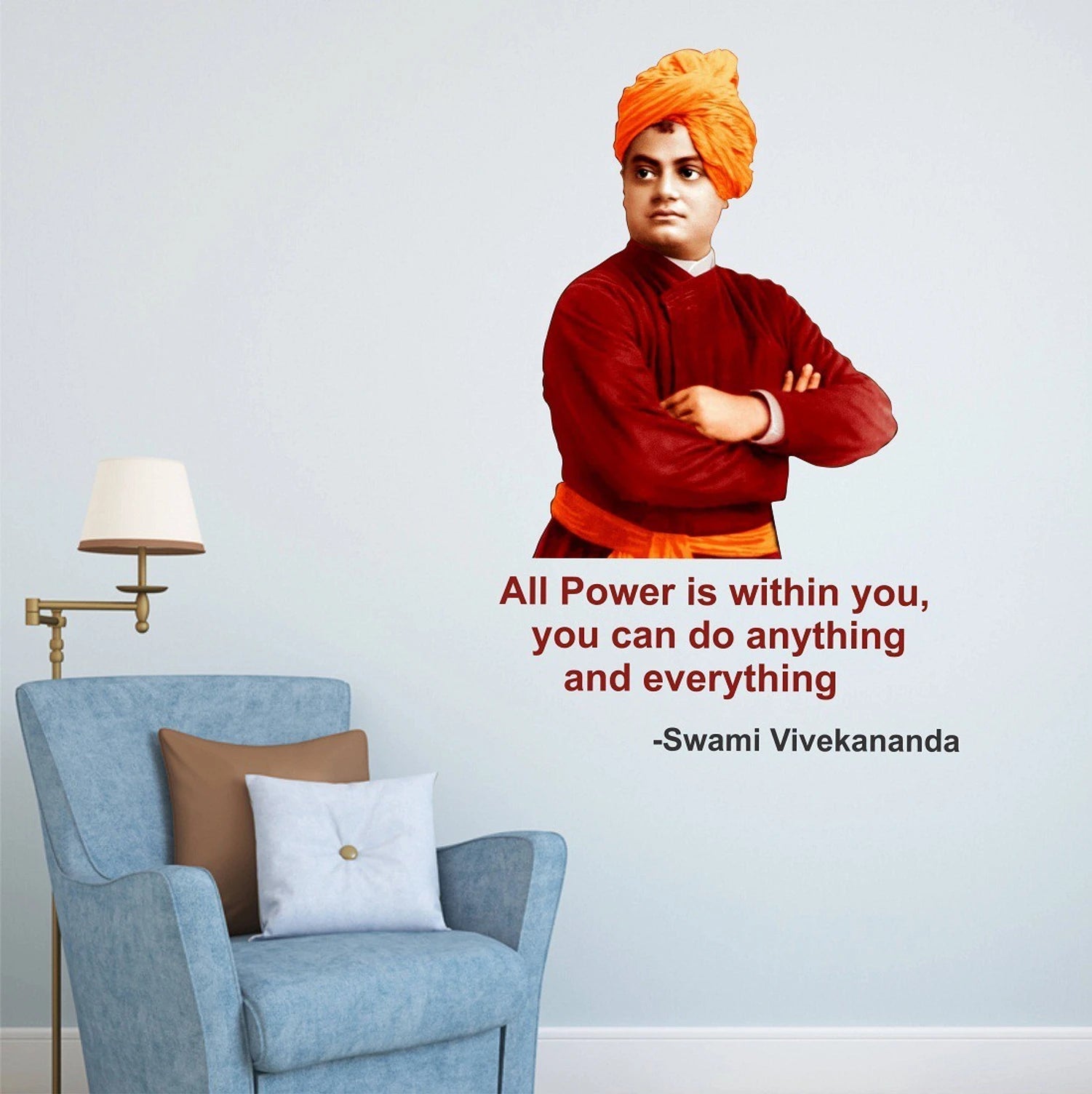 Swami Vivekananda in red outfit with orange turban in a room with a blue armchair and lamp.