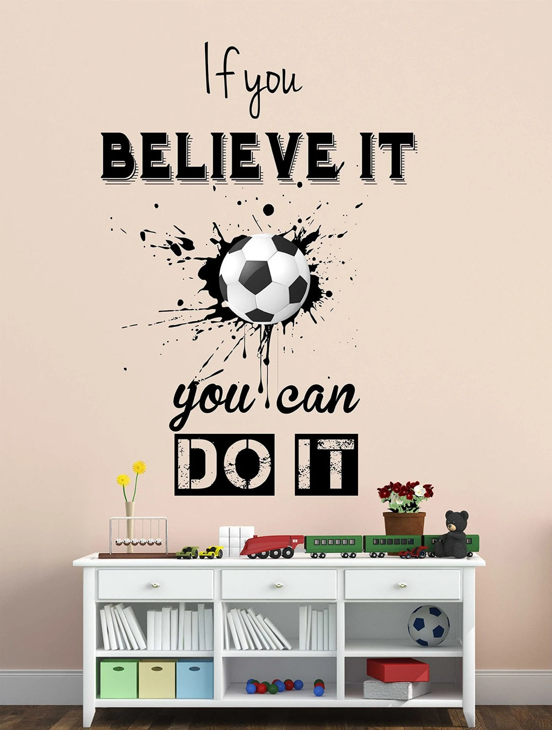 Wall decal with soccer ball and motivational quote on a wall above a white shelf.