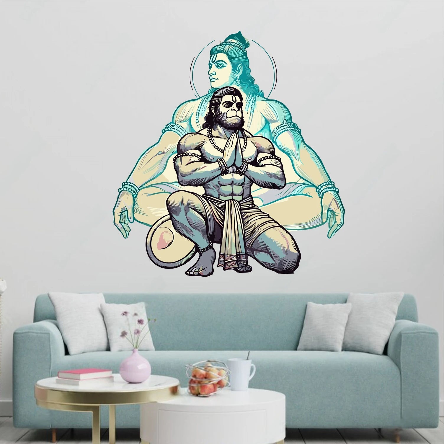 Wall decal of Hanuman on a light blue sofa with a coffee table.
