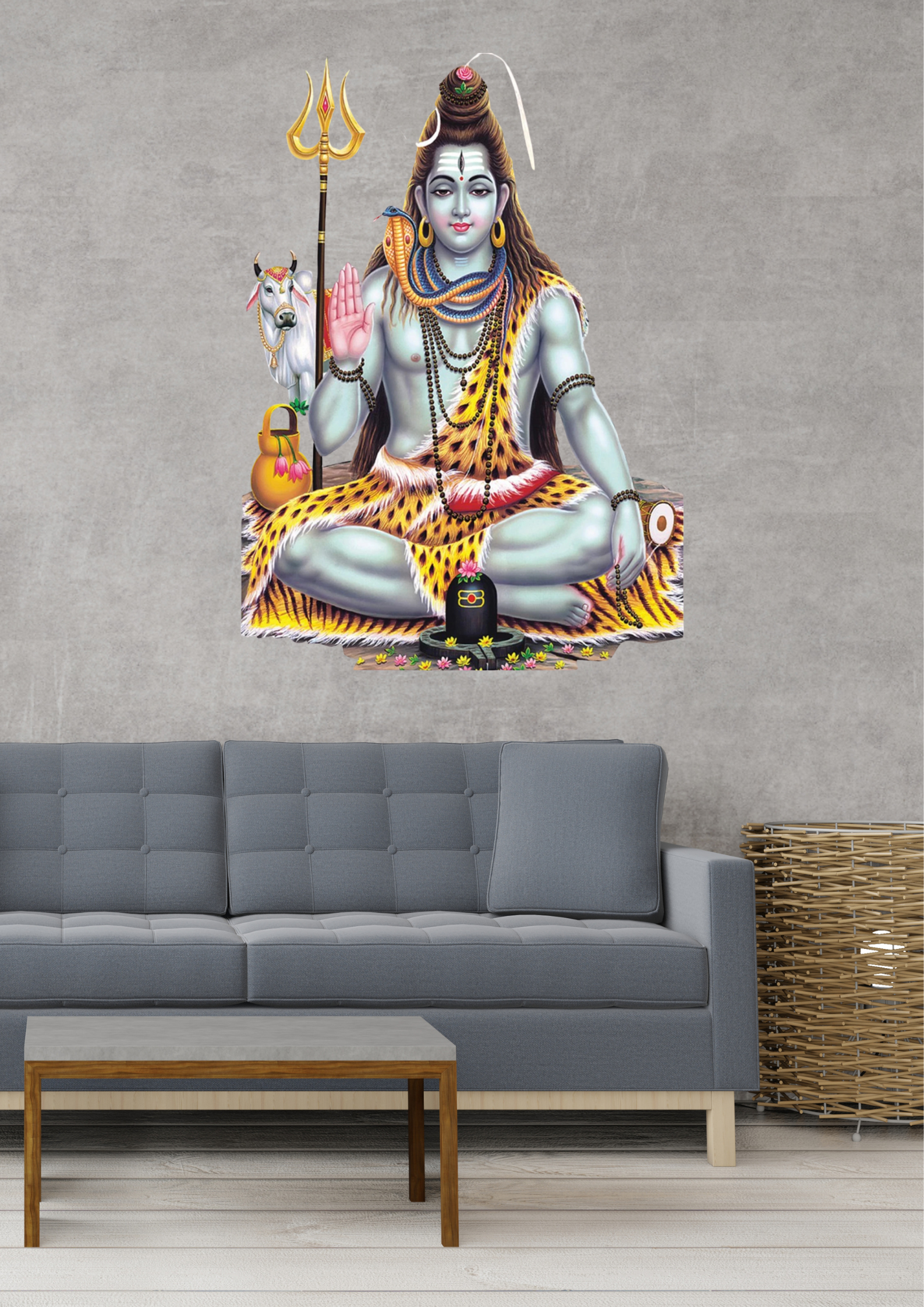 Wall mural of a seated Shiva with a trident on a gray wall above a sofa.