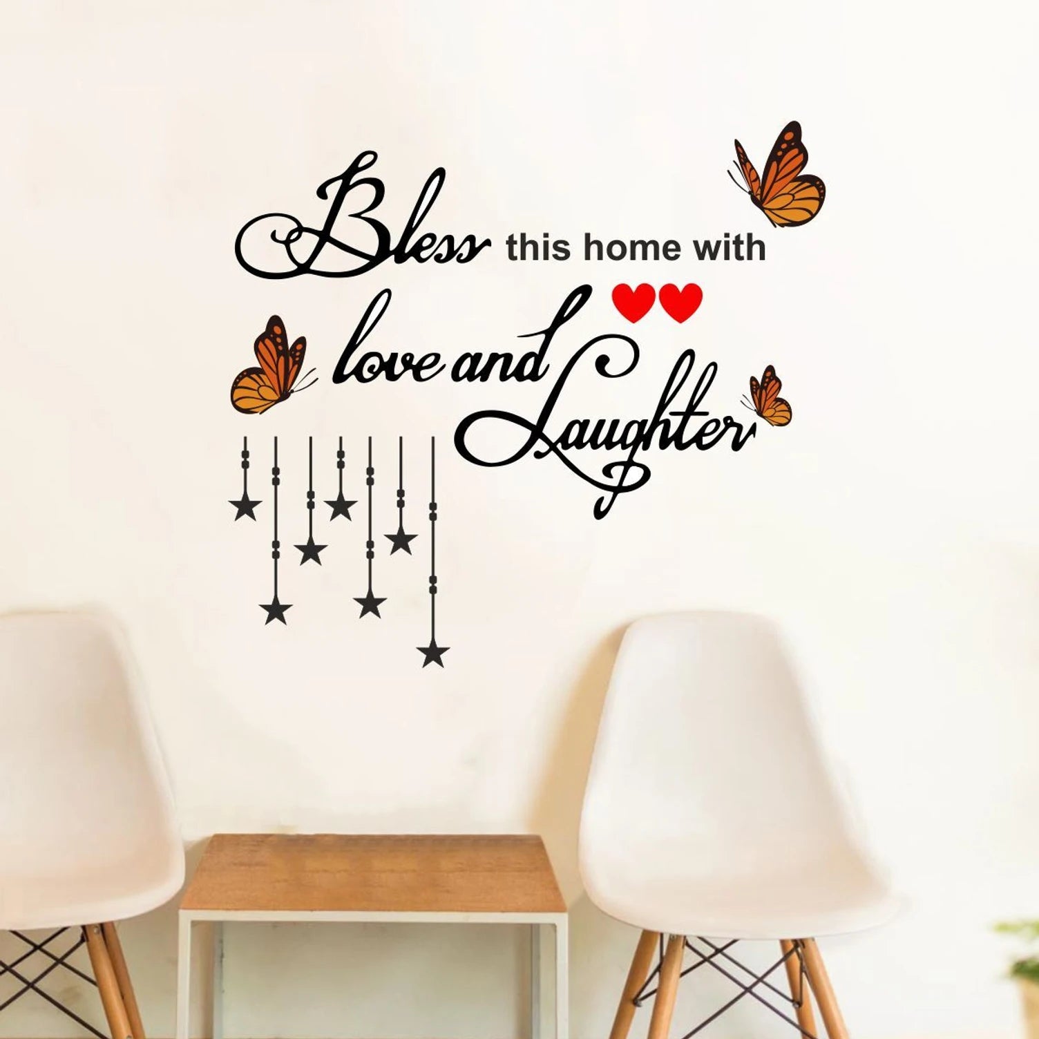Wall decal with 'Bless this home with love and laughter' text and decorative elements on a wall.