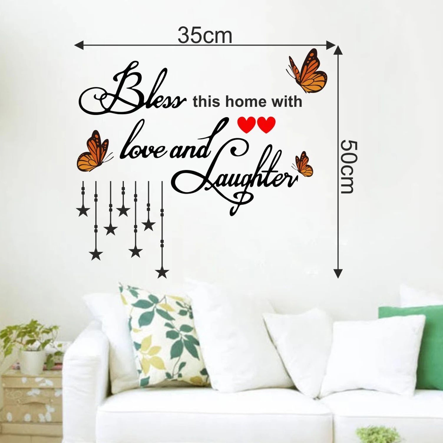 Wall decal with text 'Bless this home with love and laughter' on a wall above a sofa with Dimensions.