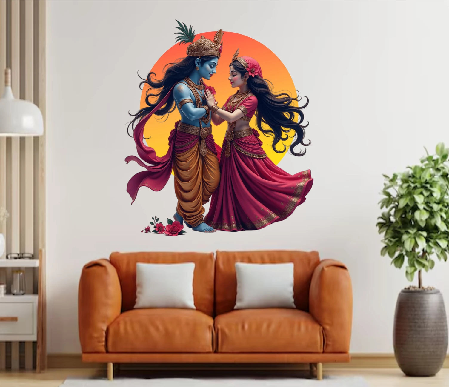 Wall decal of Radha Krishna  dancing in a living room with a brown sofa and plant.