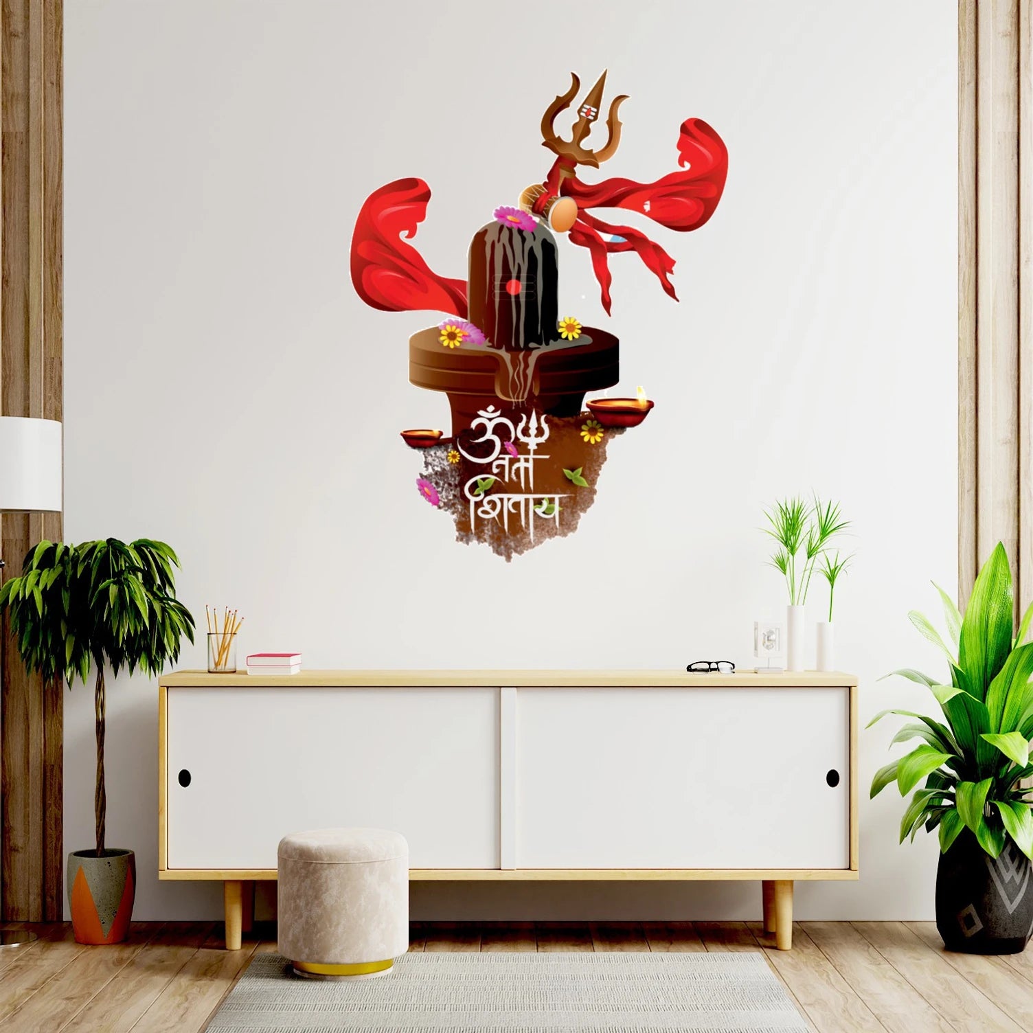 Decorative wall sticker with religious symbols on a white wall above a wooden cabinet.