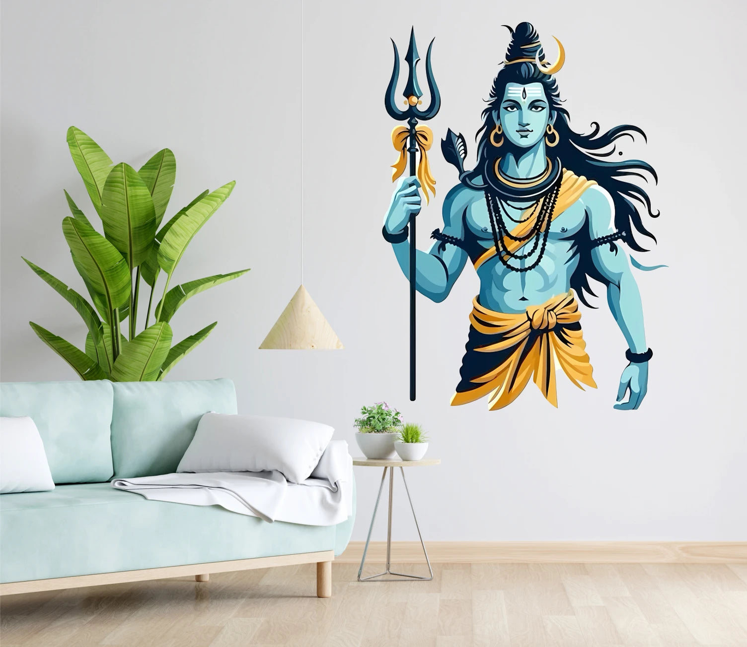 Wall mural of a Shiva holding a trident in a living room setting with a couch and plants.