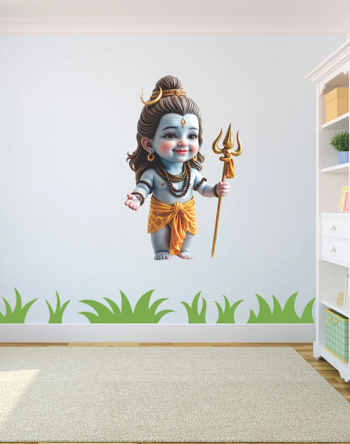 Wall decal of a child Mahadev holding a trident in a room with a white wall and green grass border.